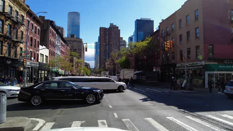 Pov-shot-of-white-luxury-limousine-on-road-in-New-York-City-during-summer-day---tracking-shot