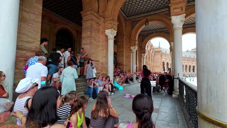 People-enjoy-flamenco-show-in-Plaza-de-España,-Seville,-slow-motion