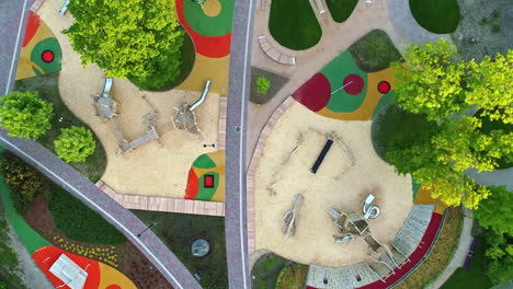 Aerial-top-down-shot-above-a-modern,-newly-landscaped-park-and-playground