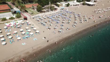 aerial-top-down-of-people-sunbathing-in-private-resort-Bech-in-Montenegro-Adriatic-Sea-becici-holiday-destination