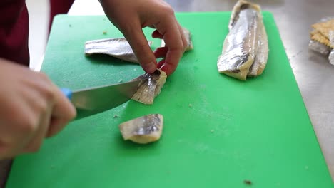 Chef-cutting-up-fish-in-the-restaurant-kitchen
