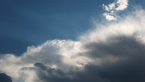 Moving-summer-clouds-time-lapse-against-blue-sky-and-sun-rays