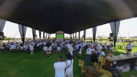 Experience-the-vibrant-scene-of-a-football-game-set-on-a-farm,-where-every-participant-is-dressed-in-white