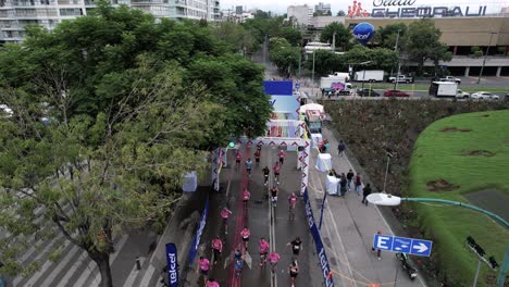 drone-shot-of-runners-at-maraton-de-la-ciudad-de-mexico-crossing-finish-line