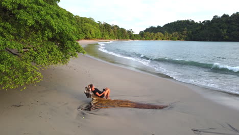Aerial-perspective-of-caucasian-female-tourist-relaxing-on-the-remote-beach-in-Costa-Rica