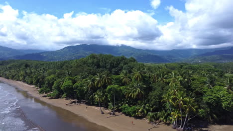 Scenic-aerial-landscape-view-of-tropical-beach-and-the-nature-park-Manuel-Antonio-in-Costa-Rica-with-a-cloudy-sky