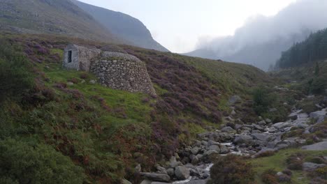Static-establishing-view-of-historic-restored-ice-house-in-Slieve-Donard,-Northern-Ireland-on-misty-day