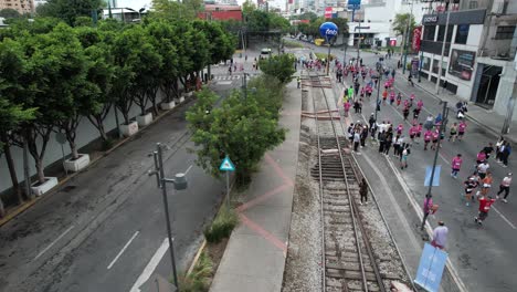 drone-shot-of-maraton-de-la-ciudad-de-mexico-with-railroad-track