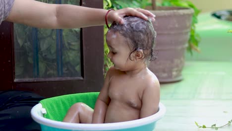 toddler-enjoying-bathing-with-shampoo-and-soap-in-tub-at-outdoor-from-unique-perspective
