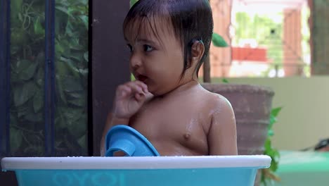 toddler-enjoying-bathing-in-tub-at-outdoor-from-unique-perspective