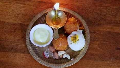 copper-plate-filled-with-rakhi-sweets-and-oil-lamp-on-the-occasion-of-raksha-bandhan