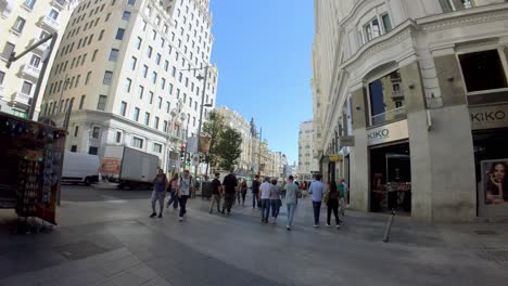 Madrid,-Spain:-Wander-down-Gran-Via,-Madrid's-lively-boulevard,-through-the-lens-of-our-gimbal-shot,-and-discover-the-city's-endless-charm