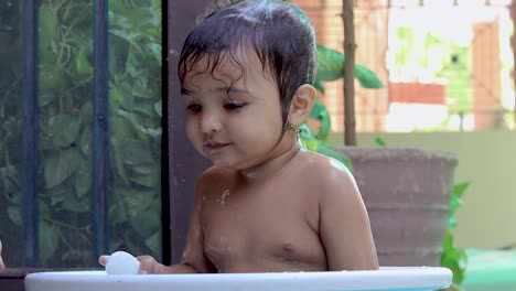 toddler-enjoying-bathing-in-tub-at-outdoor-from-unique-perspective