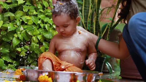 cute-toddler-baby-boy-bathing-with-soap-in-decorated-bathtub-at-outdoor-from-unique-perspective