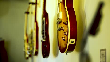 Five-classic-guitars-adorn-the-wall-as-a-collector's-showcase,-with-a-shift-in-focus-from-the-foreground-to-the-background