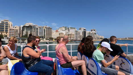 Slow-motion-shot-of-tourists-on-a-sightseeing-boat-in-Valletta-Malta