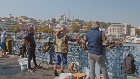 Fishing-along-the-Galata-bridge-with-Istanbul-skyline-backdrop