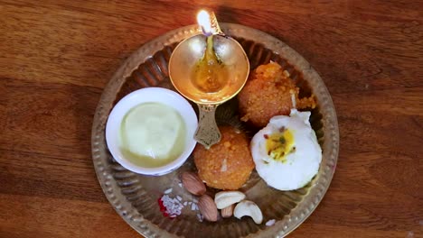 copper-plate-filled-with-rakhi-sweets-and-oil-lamp-on-the-occasion-of-raksha-bandhan