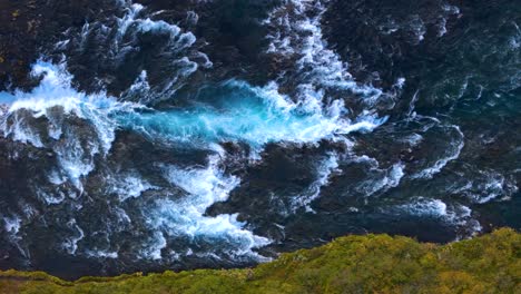 Top-down-shot-of-tropical-blue-rapids-winding-through-the-countryside-in-Iceland