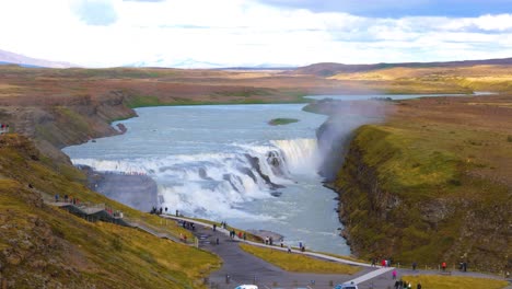 Aerial-parallax-shot-of-the-Gullfoss-Falls-with-tourists-watching-from-the-viewpoint