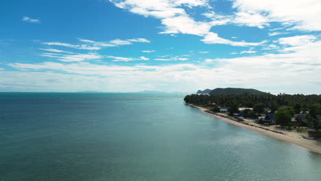 Iconic-remote-township-on-sandy-coastline-of-Thailand,-aerial-view