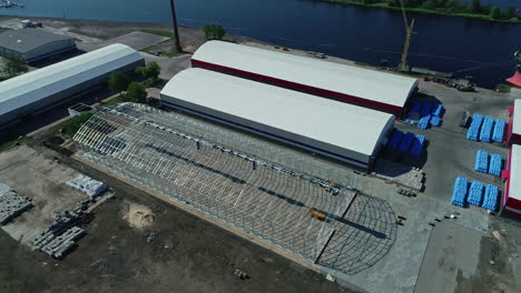 Construction-site-of-grain-warehouse-near-old-ones,-aerial-drone-view
