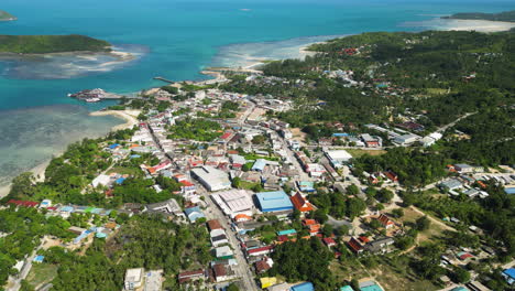 Drone-shot-with-blue-water-surrounding-Pantip-capital-of-Koh-Phangan-Party-island