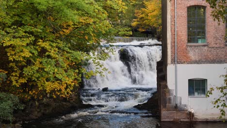 waterfall-by-old-building-during-fall