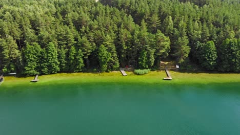 Aerial-view-of-a-lake-Jezioro-Gwiazdy-surrounded-by-trees