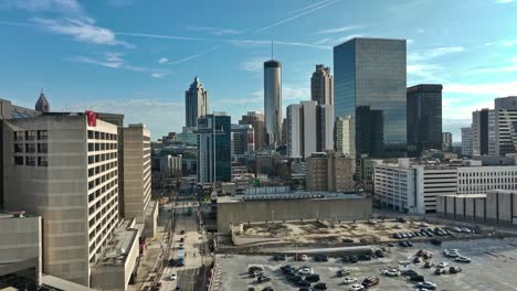 Aerial-establishing-shot-showing-parking-cars-and-modern-skyscraper-buildings-in-Downtown-of-Atlanta-City