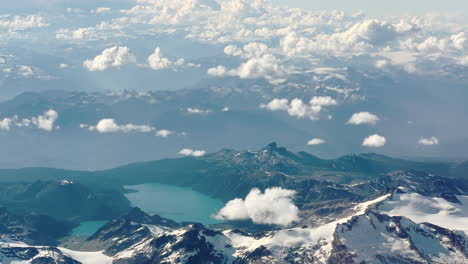 Aerial-shot-of-a-mountain-lake-in-the-midst-of-glaciers,-in-British-Columbia