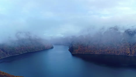 Magical-fjord-in-Norway-covered-in-fog,-aerial-drone-view