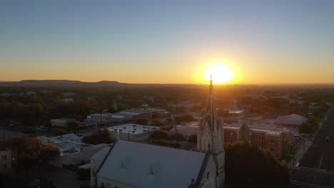 Saint-Mary's-Catholic-Church-backlit-by-stunning-sunset,-Fredericksburg-Texas