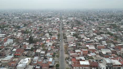 Panoramic-aerial-view-of-Villa-Fiorito,-Overcrowded-slums-in-Argentina-capital-under-foggy-sky-due-to-climate-change