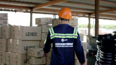 moving-shot-of-worker-carrying-boxes-in-customs