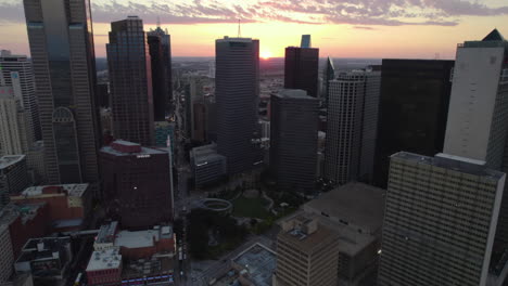 Aerial-view-tilting-toward-the-Pacific-Plaza-park,-sunset-in-Dallas,-Texas,-USA