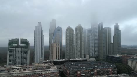 High-rise-residential-buildings-and-luxury-hotels-under-foggy-sky-due-to-climate-change,-Buenos-Aires,-Argentina,-Drone-shot