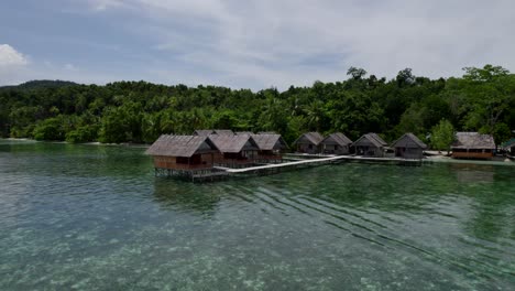 Raja-Ampat-aerial-of-the-beach-and-reef-and-huts-on-a-hot-sunny-day