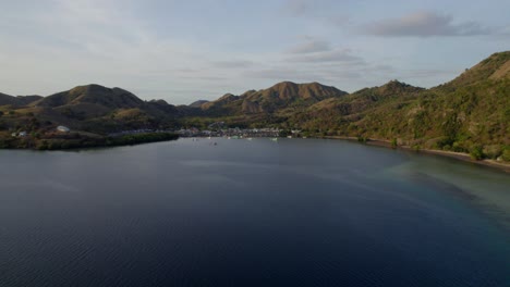 Komodo-aerial-of-the-beach-and-reef-on-a-hot-sunny-day-at-sunset