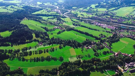 aerial-flight-over-green-valley-and-small-villages,-4k