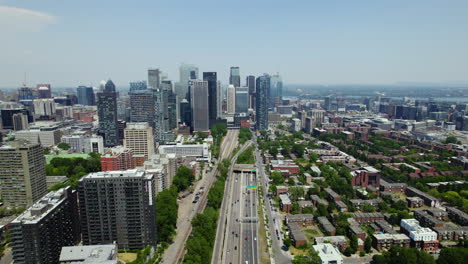 Aerial-view-backwards-along-the-Boulevard-Ville-Marie,-in-sunny-Montreal,-Canada