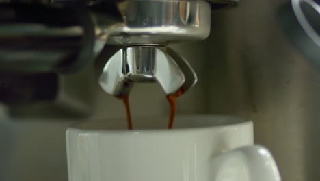 Coffee-liquid-pours-out-of-a-metal-spigot