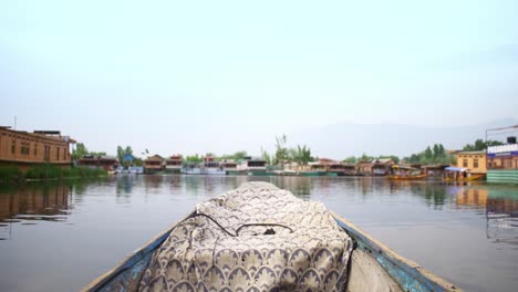 POV-from-a-Shikara-gently-gliding-through-the-Dal-lake-in-Srinagar,-Kashmir