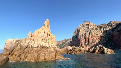 Stunning-footage-of-Calanques-de-Piana-rock-formations-in-Corsica,-France,-as-seen-from-tour-boat-on-Mediterranean-Sea-in-summer-season