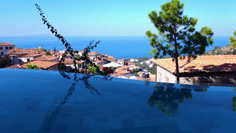 Luxury-Hotel's-Infinity-Pool,-Overlooking-the-Azure-Sea,-and-Stone-Resort-–-The-Epitome-of-Opulence-and-Relaxation