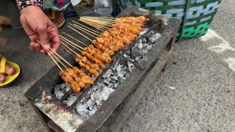 The-popular-Malaysian-and-Indonesian-street-food,-Satay,-is-cooked-on-a-flaming-barbecue-grill