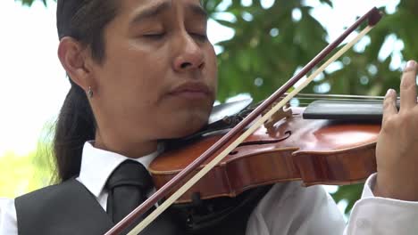 Close-up-shot-of-a-violinist-playing-music-and-feeling-the-rhythm