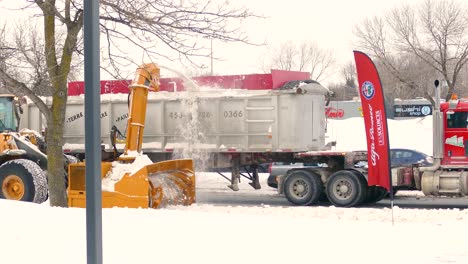 A-snowplow-removes-heavy-snowfall-from-the-Canadian-roadside