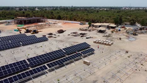 Unveiling-huge-photovoltaic-power-plant-with-solar-panels-and-buildings-under-construction-in-Jambur,-Gambia