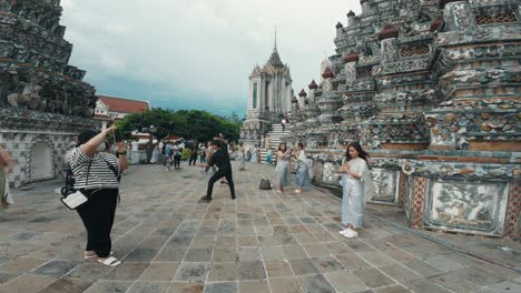 Several-individuals-capturing-photos-at-Wat-Phra-Mahathat-Woramahawihan,-the-principal-Buddhist-temple-of-Nakhon-Si-Thammarat-Province-in-southern-Thailand